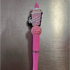 Skeleton hand with coffee ink pen